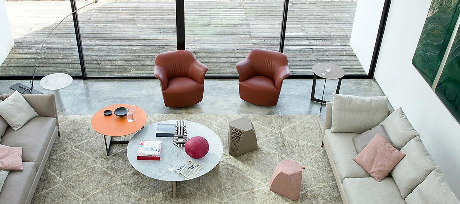 Aida armchair by Poltrona Frau, in Pelle Frau® leather and warm colors, example of Italian craftsmanship and design.