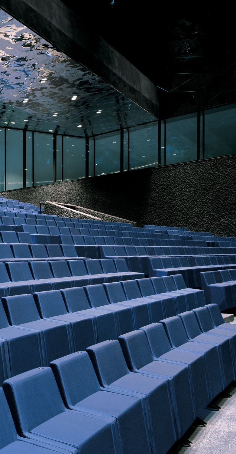 BCN | Armchair BCN by Poltrona Frau is a compact and sculptural armchair designed by Herzog & de Meuron, featuring geometric volumes and exquisite handcrafted details.