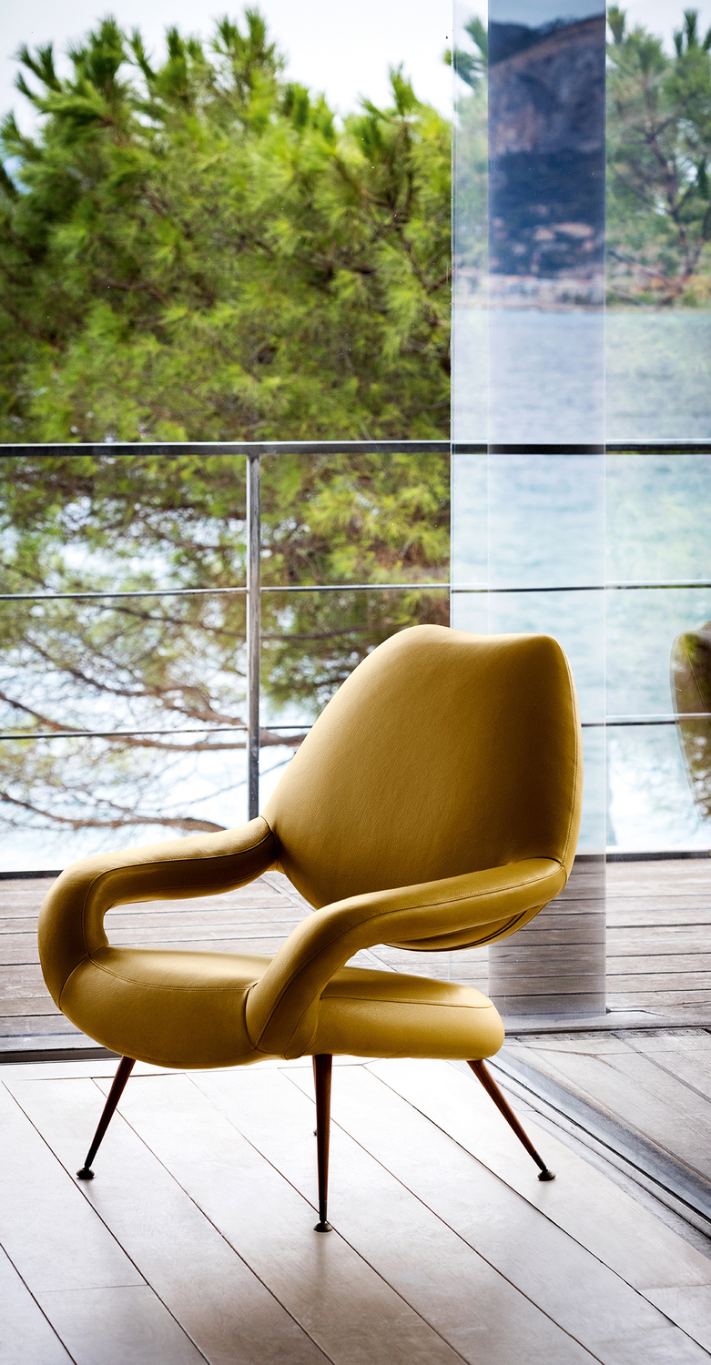 Du 55 | Fauteuil  Fauteuil Du 55 Poltrona Frau, design Gastone Rinaldi, cuir Pelle Frau®, coque incurvée, rembourrage en mousse de polyuréthane moulée, pieds coniques en acier finition laiton ou teck, élégance italienne