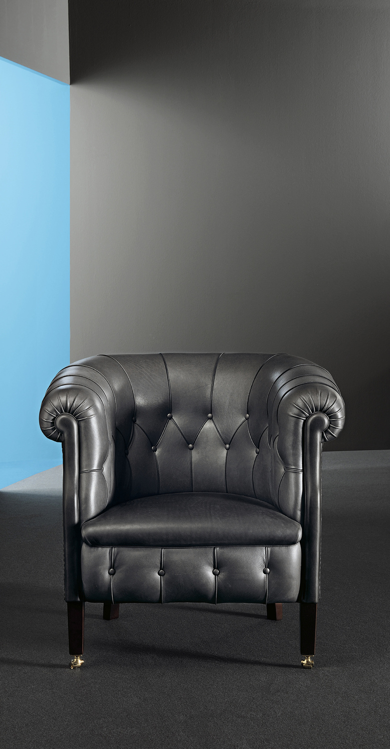 Fumoir | Armchair Fumoir armchair by Poltrona Frau with seasoned beech structure, diamond-pattern stitching, Pelle Frau® covered buttons and brass wheels, expression of Italian elegance and outstanding design