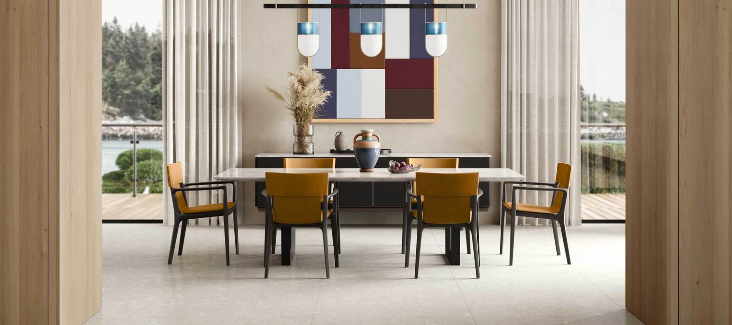 Isadora | Chair with arms Isadora chair with arms by Poltrona Frau, moka-stained ash wood frame, clean-cut Saddle Extra leather upholstery with artisanal contrast stitching