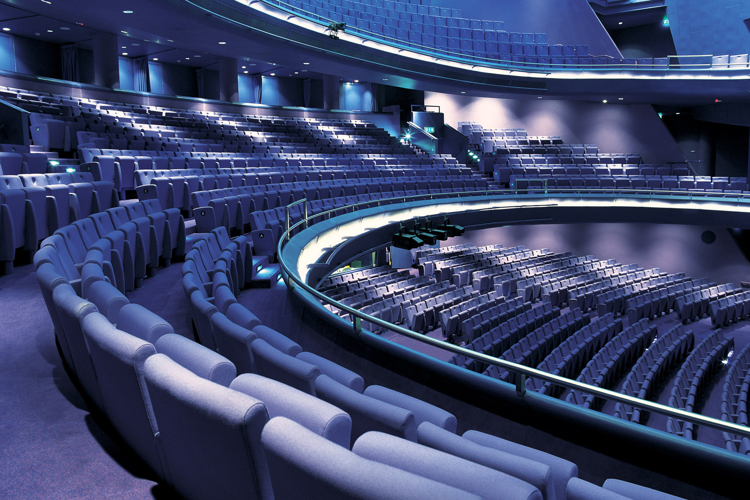 Poltrona Frau L-C: an elegant and compact seat with a solid wood structure and a foldable mechanism, designed for refined collective spaces.