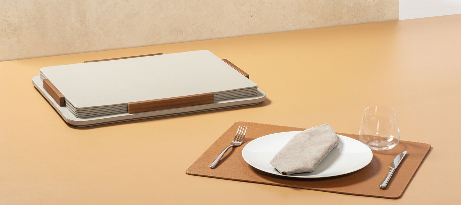 Tableware | Placemat + holder Tableware placemat holder by Poltrona Frau, design by Giobagnara, Pelle Frau® leather base with wood details, holds 6 matching placemats, Italian luxury craftsmanship and design