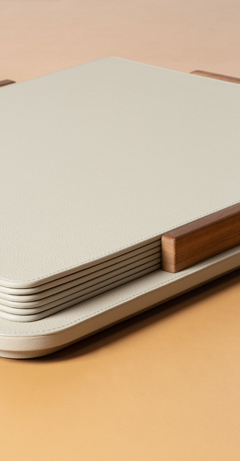 Tableware | Placemat + holder Tableware placemat holder by Poltrona Frau, design by Giobagnara, Pelle Frau® leather base with wood details, holds 6 matching placemats, Italian luxury craftsmanship and design